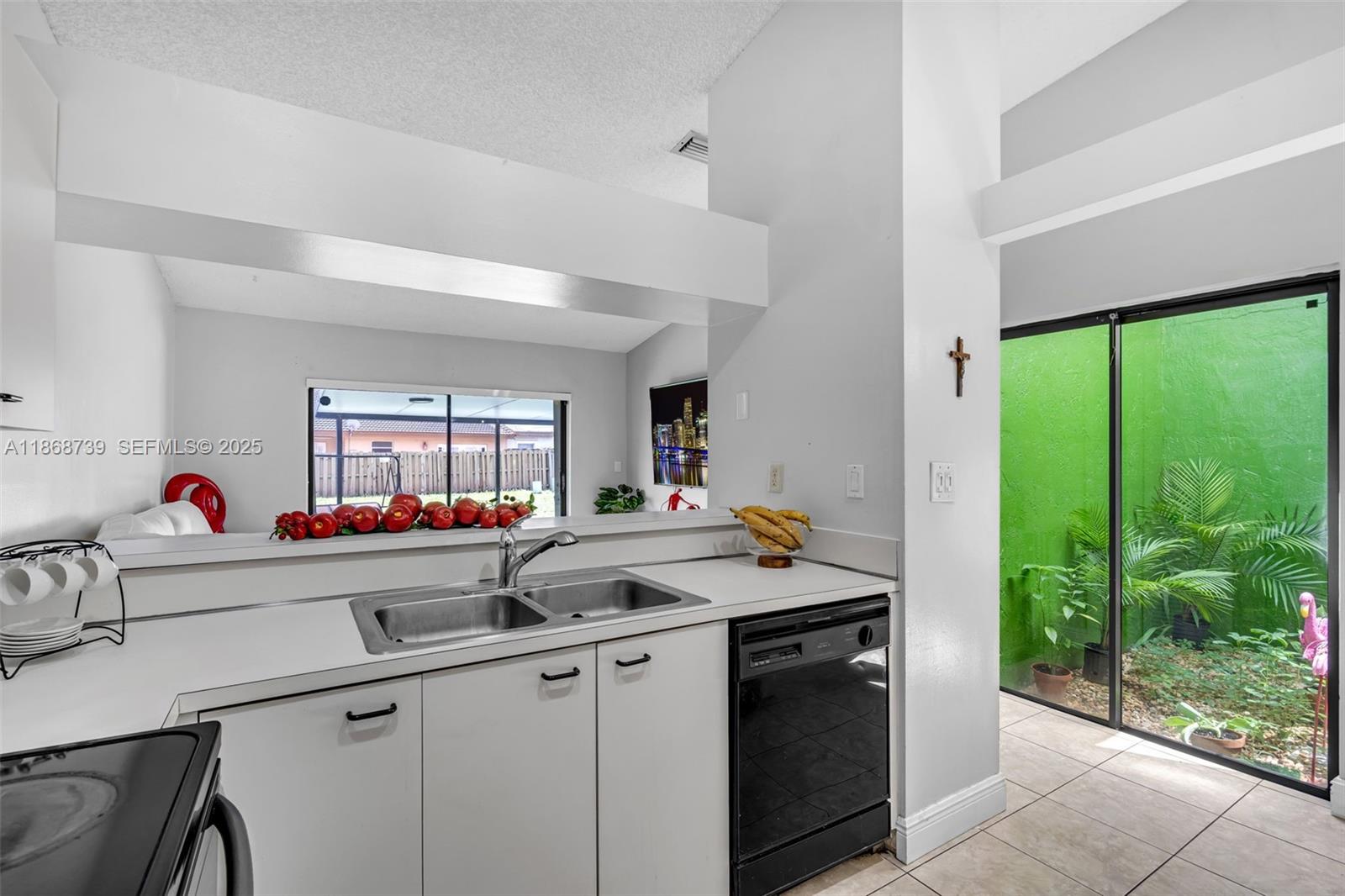 6646 Northwest 175th Terrace Hialeah, FL 33015 - Photo 9 of 33 a kitchen with a sink and a large window