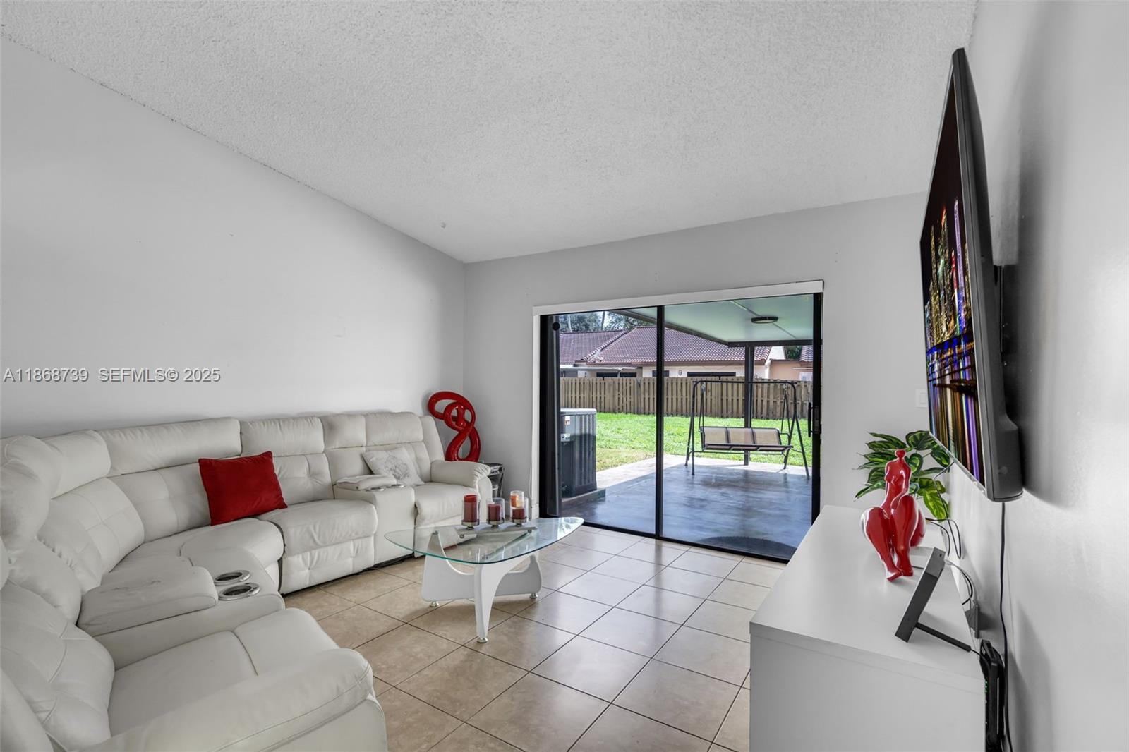 6646 Northwest 175th Terrace Hialeah, FL 33015 - Photo 10 of 33 a living room with furniture and a flat screen tv