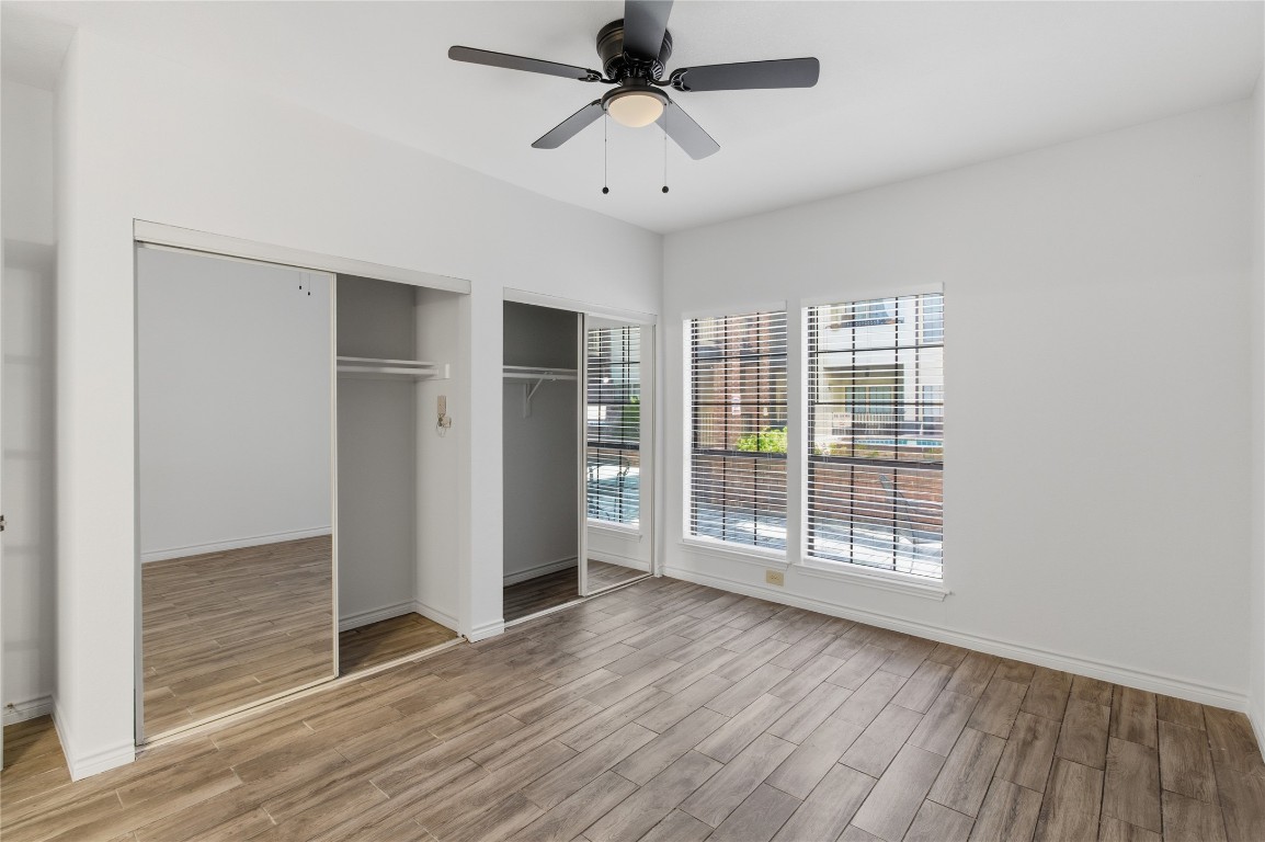3001 Cedar Street, Unit 116 Austin, TX 78705 - Photo 11 of 14 wooden floor in an empty room with a window
