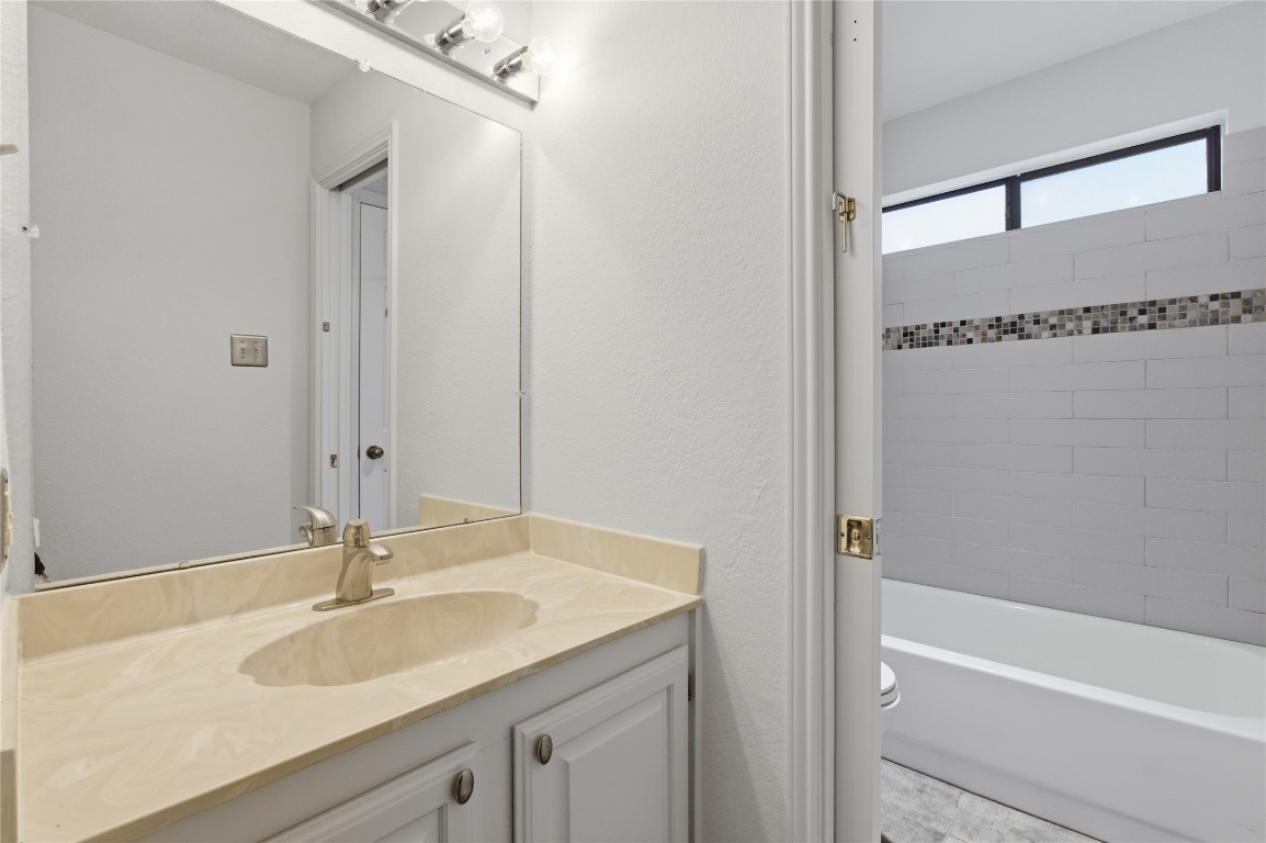 3001 Cedar Street, Unit 116 Austin, TX 78705 - Photo 12 of 14 a bathroom with a sink and a mirror