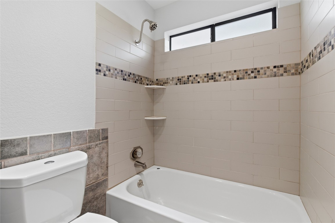 3001 Cedar Street, Unit 116 Austin, TX 78705 - Photo 13 of 14 a bathroom with a shower and a toilet