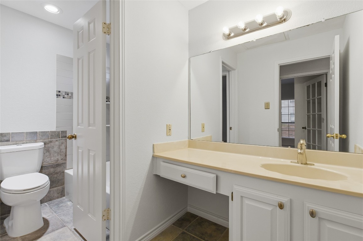 3001 Cedar Street, Unit 116 Austin, TX 78705 - Photo 14 of 14 a bathroom with a sink a toilet and a mirror