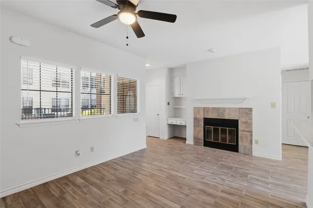 a view of empty room with a fireplace and window