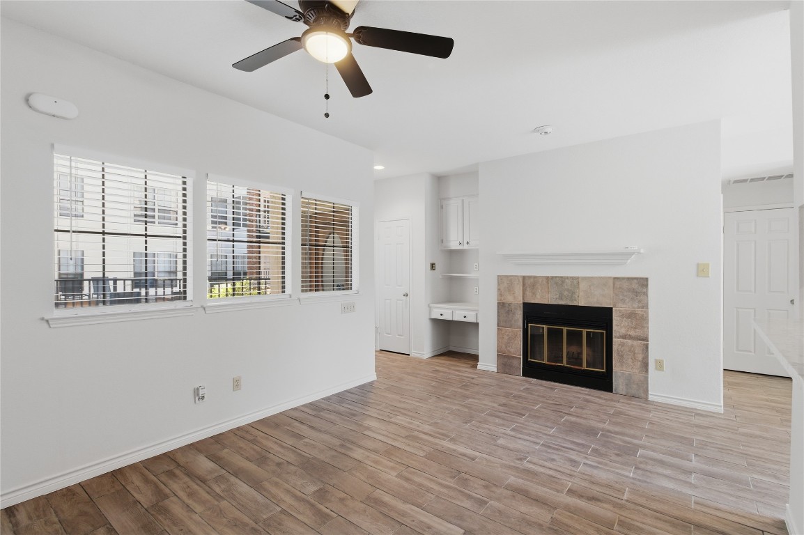 3001 Cedar Street, Unit 116 Austin, TX 78705 - Photo 5 of 14 a view of empty room with a fireplace and window