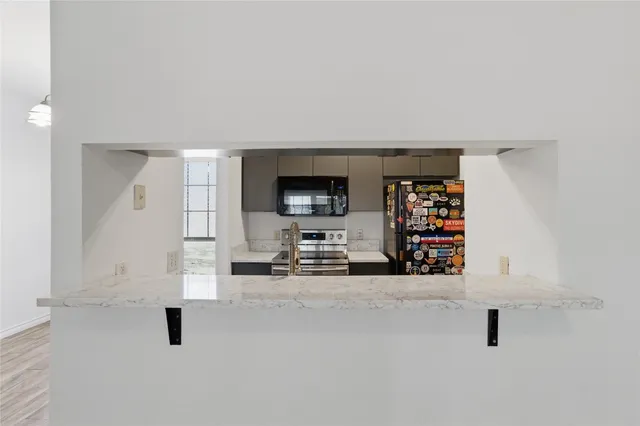 an empty room with fireplace and tv