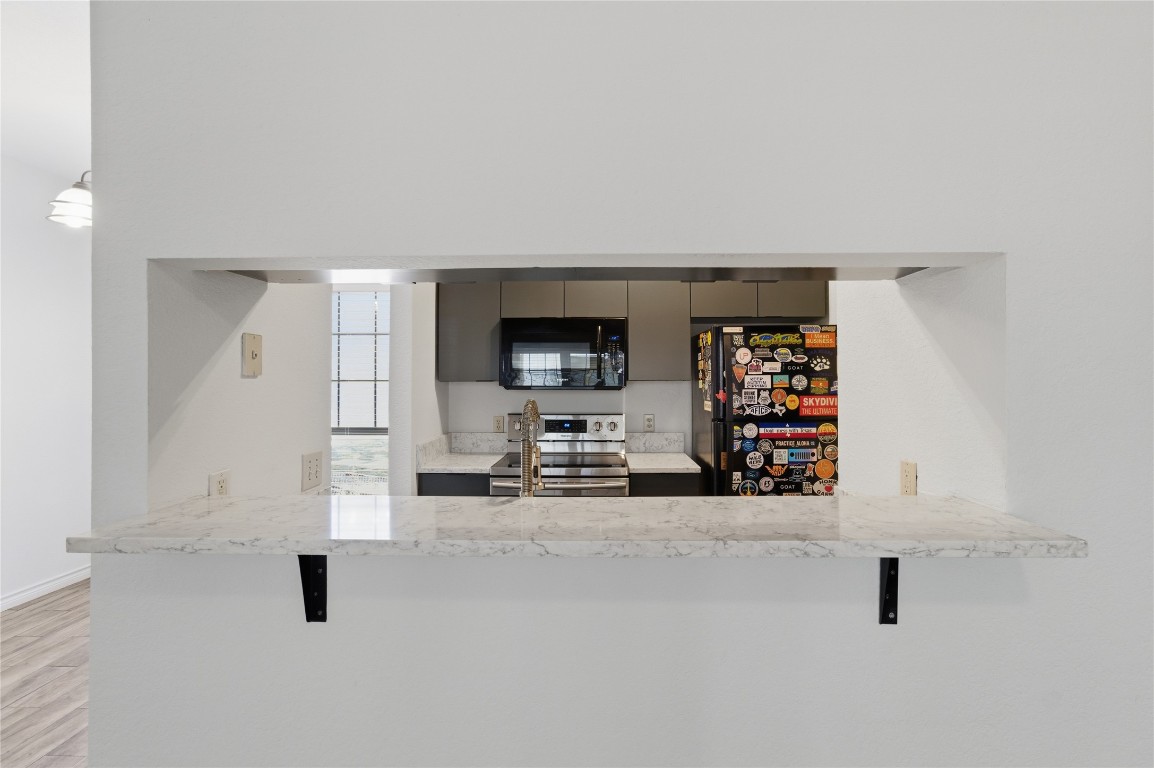 3001 Cedar Street, Unit 116 Austin, TX 78705 - Photo 6 of 14 an empty room with fireplace and tv