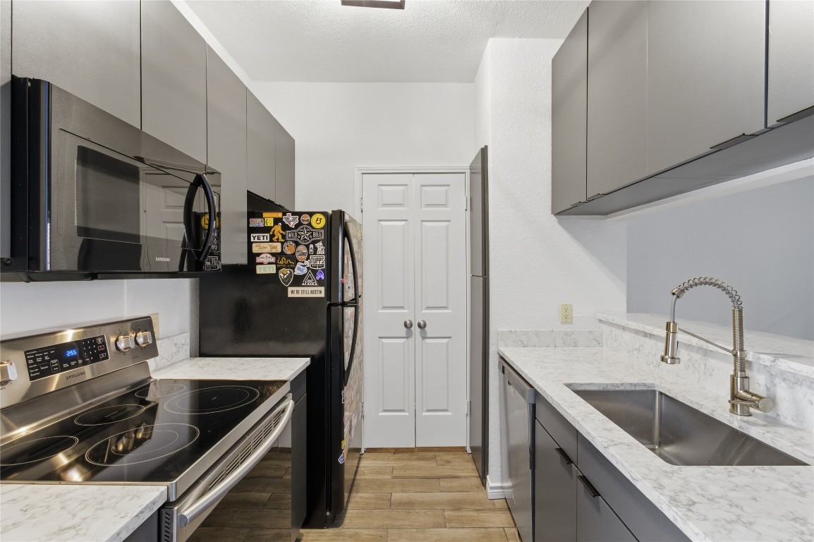 3001 Cedar Street, Unit 116 Austin, TX 78705 - Photo 7 of 14 a kitchen with stainless steel appliances granite countertop a sink stove and refrigerator