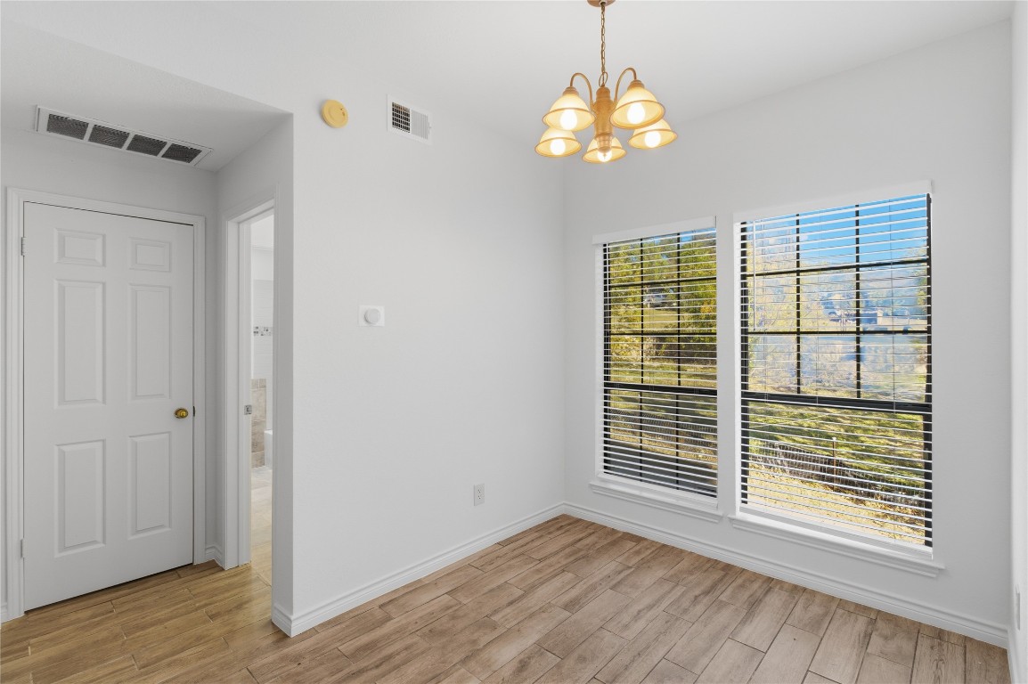 3001 Cedar Street, Unit 116 Austin, TX 78705 - Photo 9 of 14 a view of an empty room with wooden floor and a window