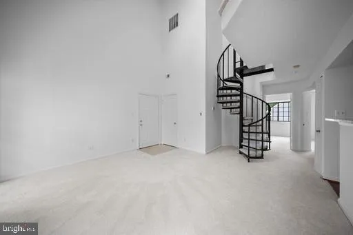 a view of an empty room with stairs