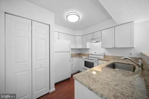 a kitchen with a refrigerator stove and sink