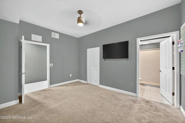 a view of an empty room with a bathroom
