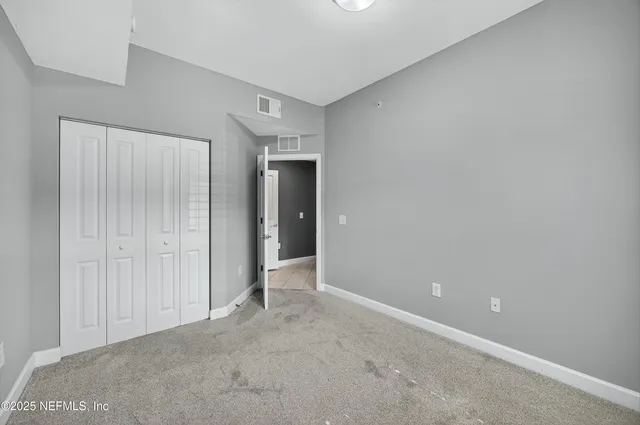 a living room with patio furniture and a floor to ceiling window