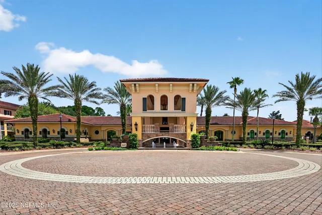 a living room with furniture a fireplace and a large window