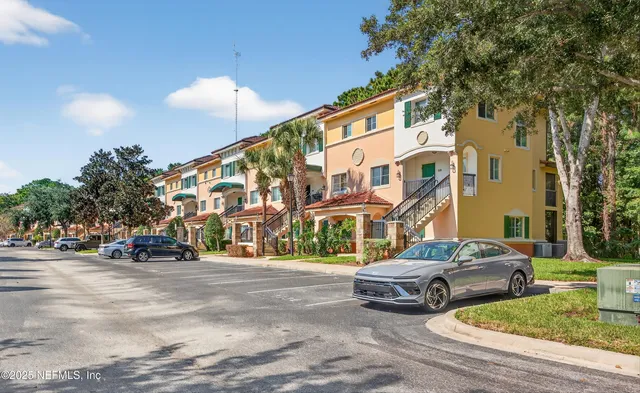 a couple of cars parked in front of a building
