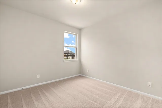 a view of an empty room and a window