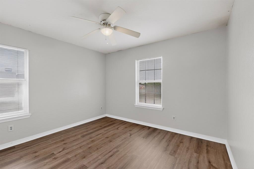 3401 Newgate Street Midlothian, TX 76065 - Photo 29 of 34 Room featuring wood-finish flooring, light gray wall paint, and white trim