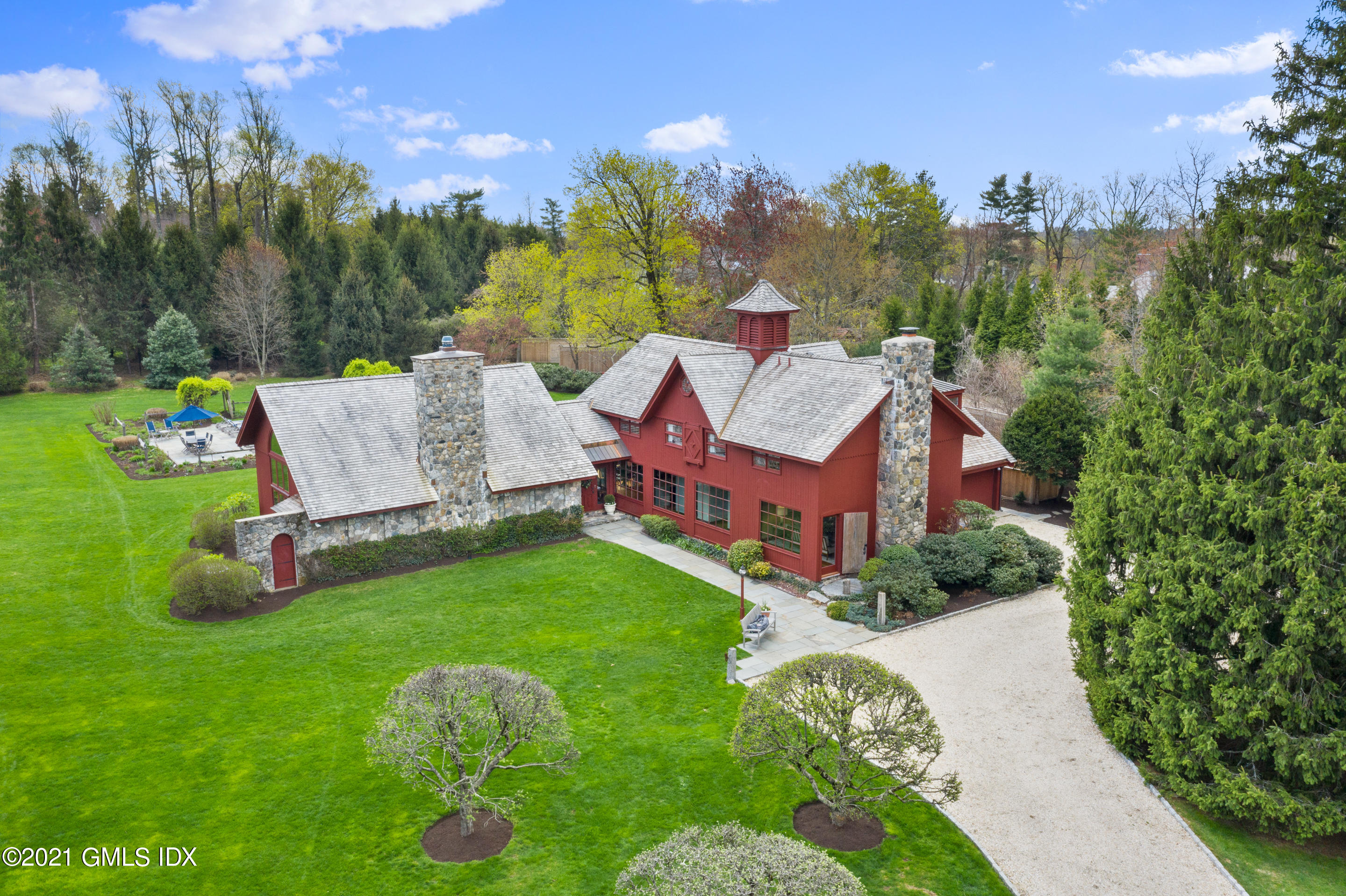 a aerial view of a house with backyard garden and trees