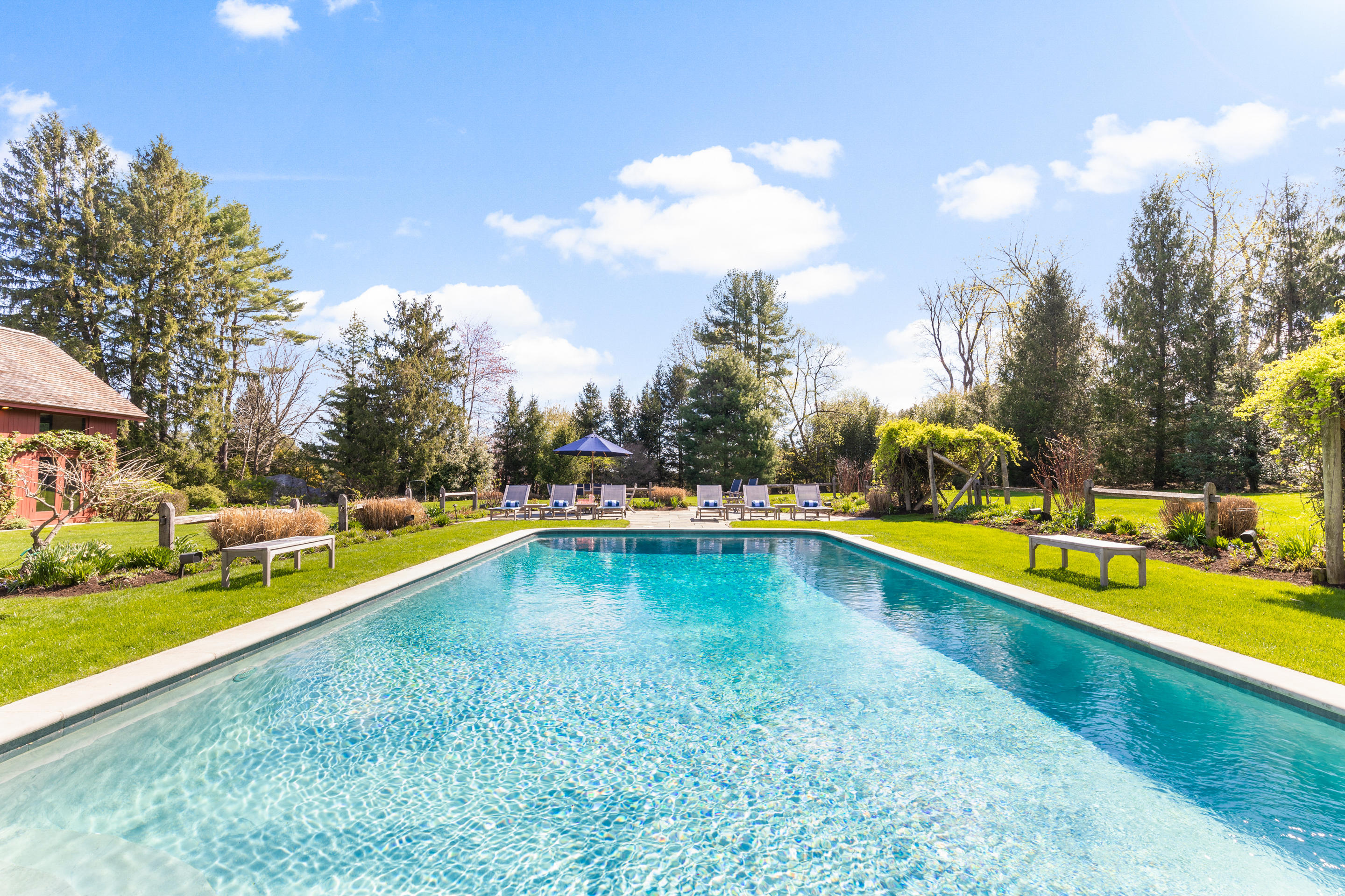 46 Dewart Road Greenwich, CT 06830 - Photo 34 of 39 a view of a swimming pool with a yard and a fountain