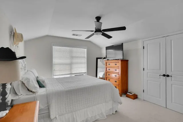 a bedroom with a bed and a flat tv screen