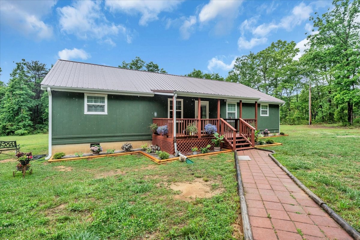 802 Meyers Road Altamont, TN 37301 - Photo 2 of 30 a view of a house with backyard sitting area and garden
