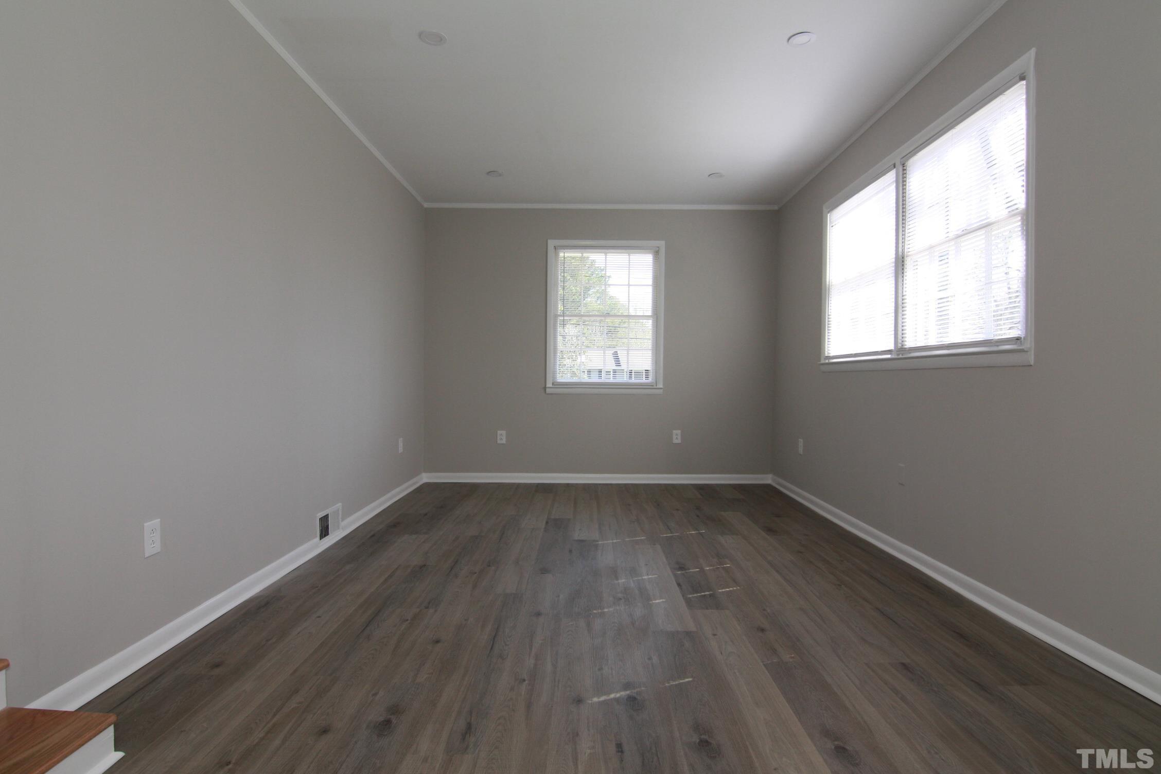 1503 Sedwick Road Durham, NC 27713 - Photo 17 of 33 an empty room with wooden floor and windows