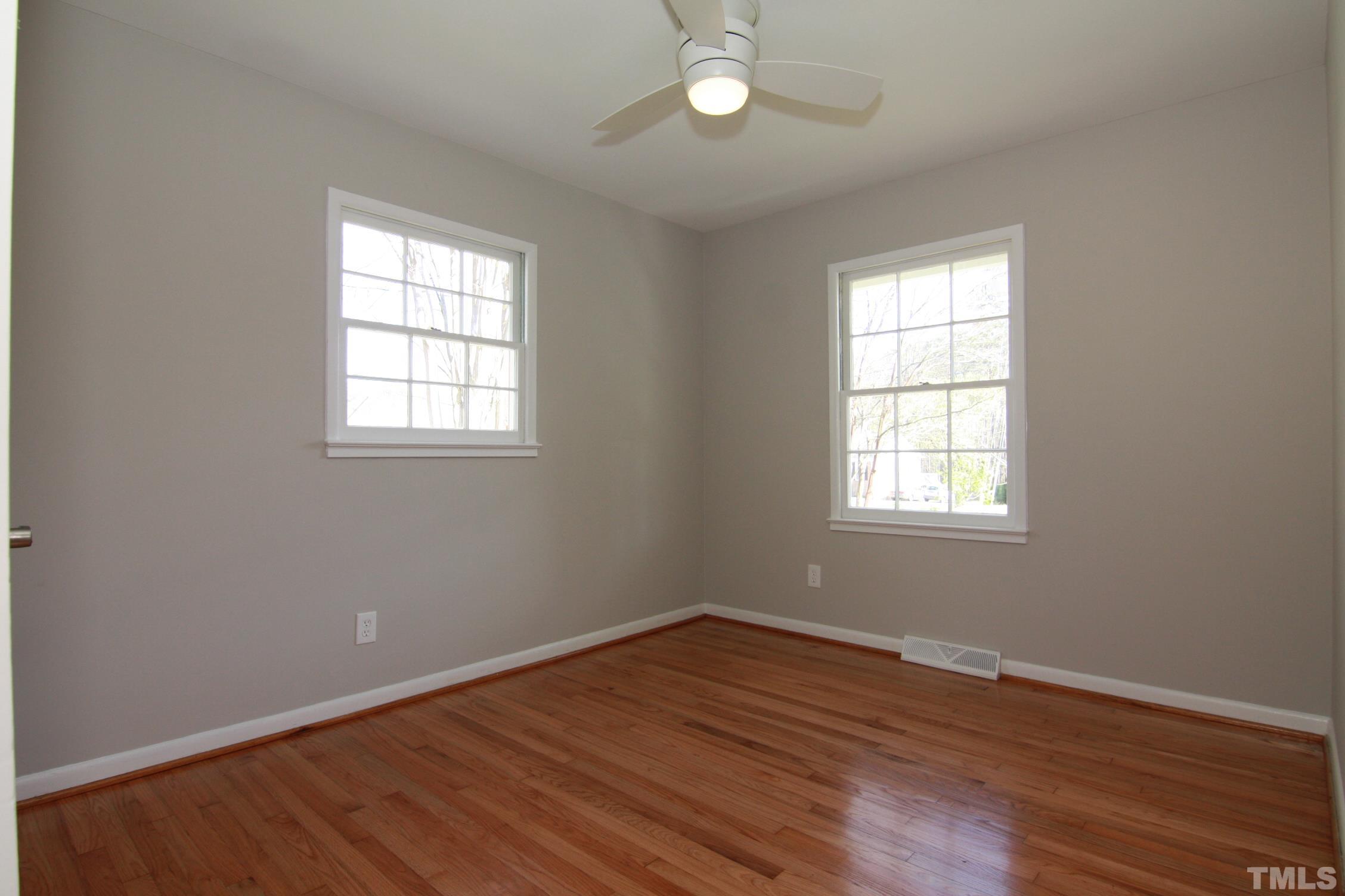 1503 Sedwick Road Durham, NC 27713 - Photo 22 of 33 an empty room with wooden floor and windows