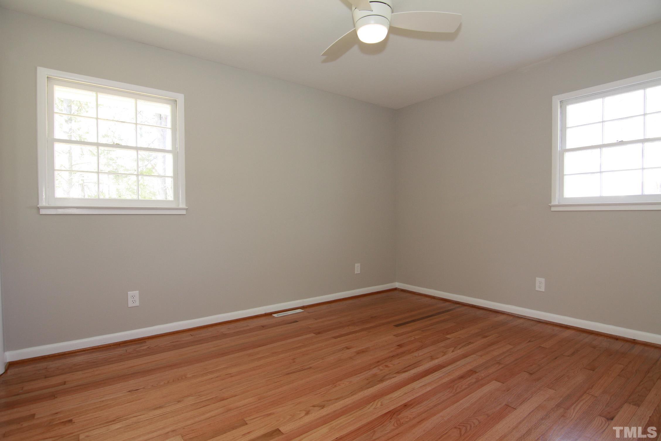 1503 Sedwick Road Durham, NC 27713 - Photo 23 of 33 an empty room with wooden floor and windows