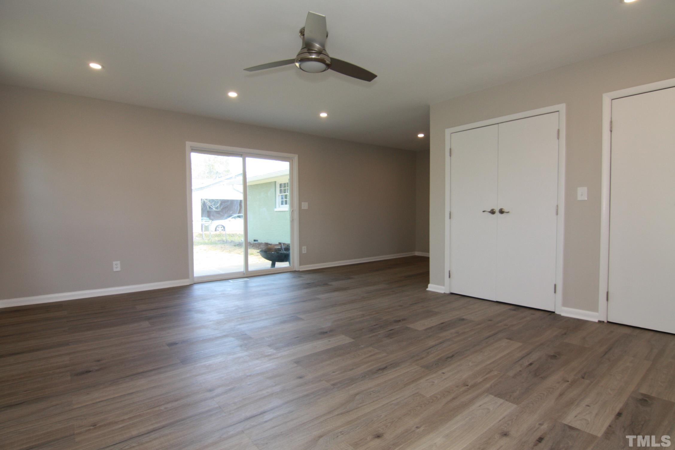 1503 Sedwick Road Durham, NC 27713 - Photo 25 of 33 a view of an empty room with wooden floor and a window