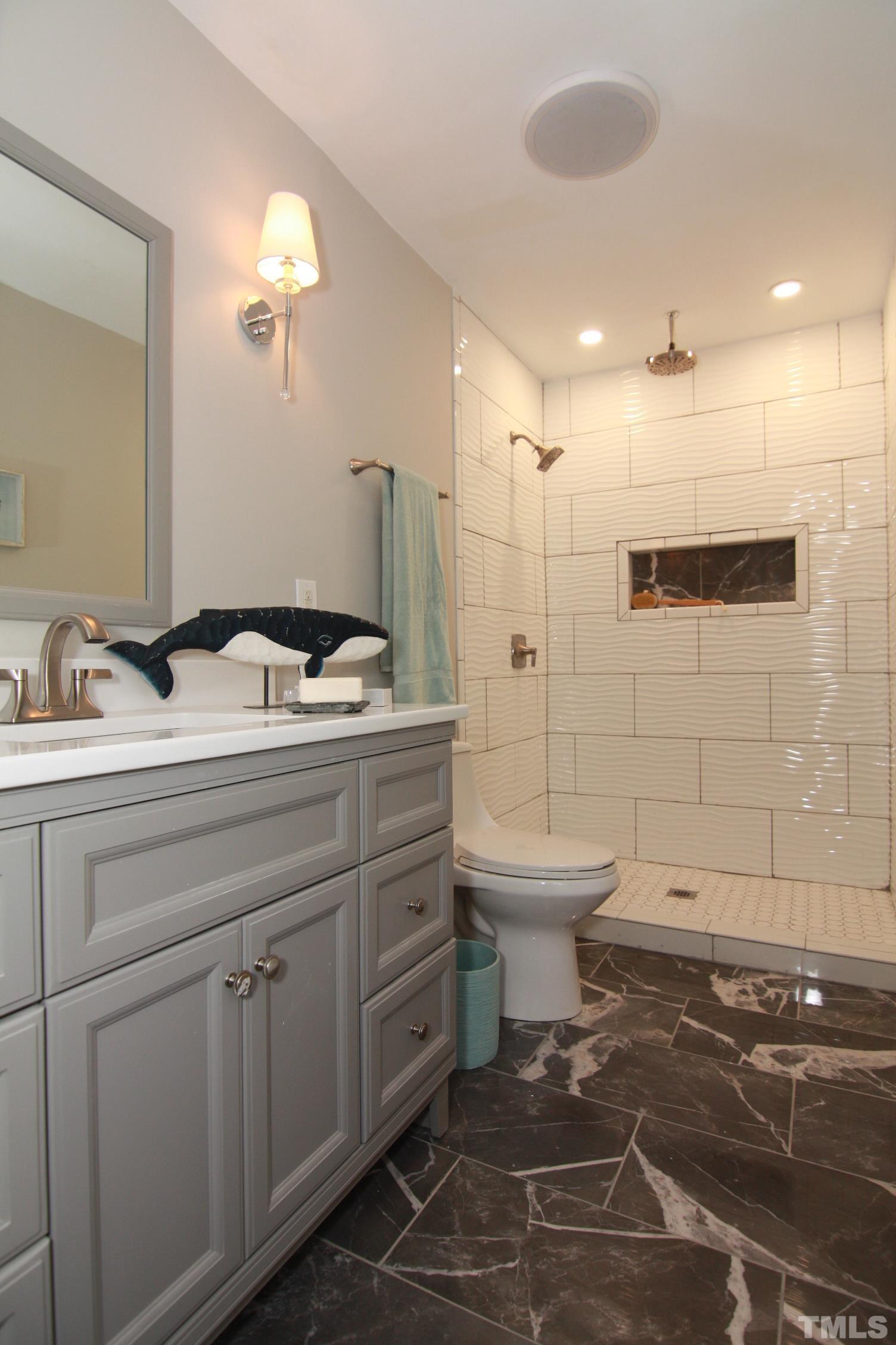 1503 Sedwick Road Durham, NC 27713 - Photo 29 of 33 a bathroom with a sink toilet and shower