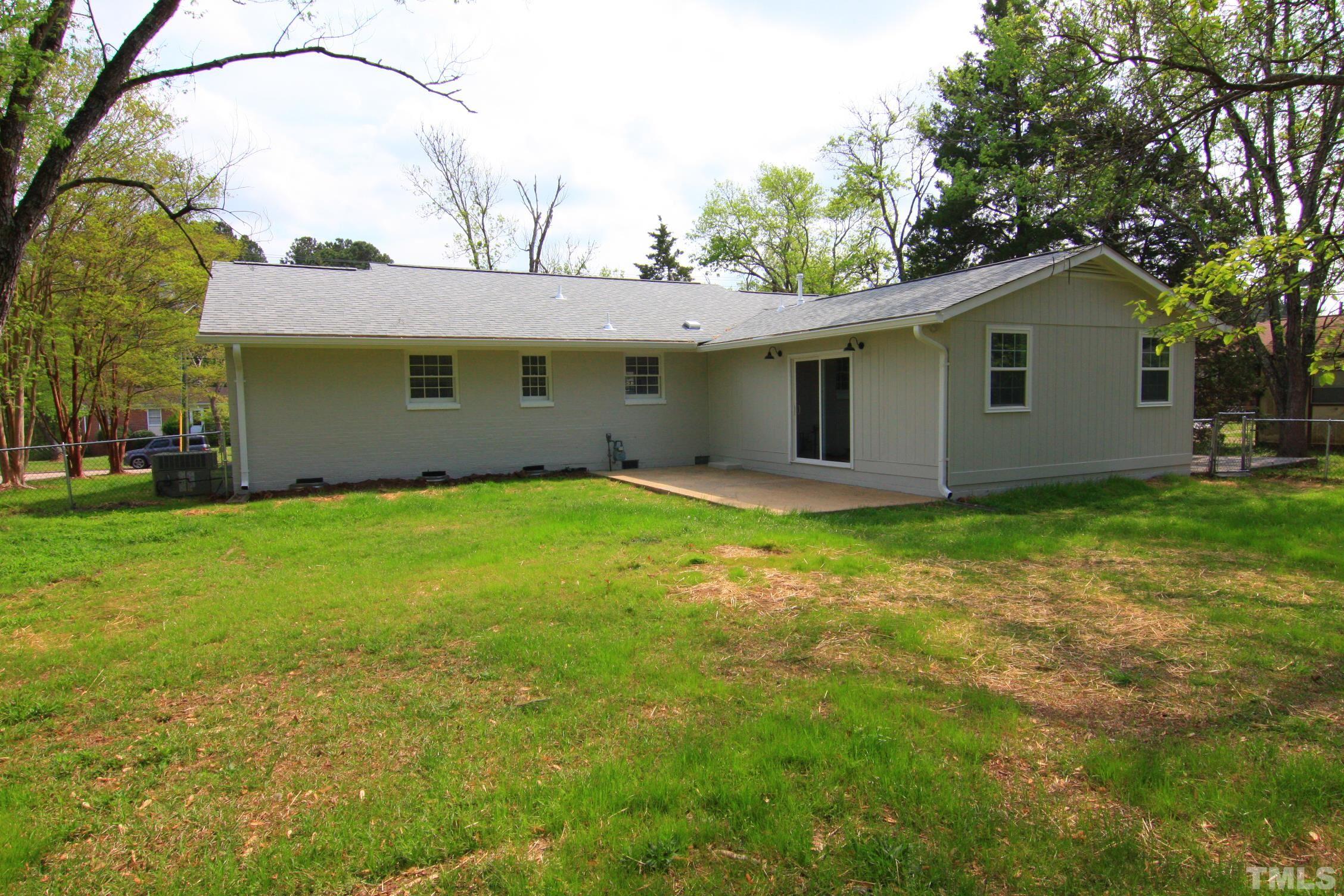 1503 Sedwick Road Durham, NC 27713 - Photo 33 of 33 a backyard of a house with plants and large tree