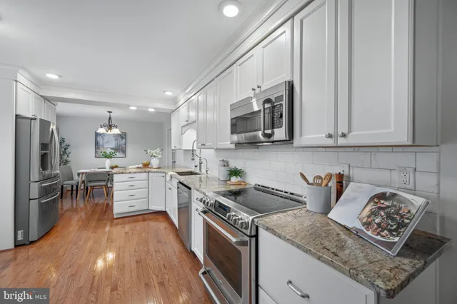 a kitchen with refrigerator and cabinets