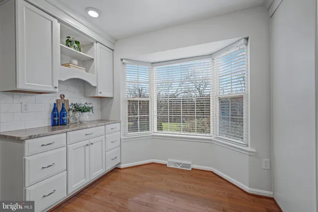 a living room with furniture a window and a fireplace