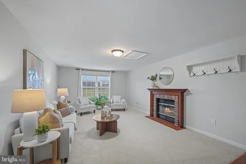 a living room with furniture stairs and a window