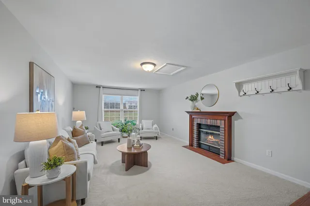 a living room with furniture stairs and a window