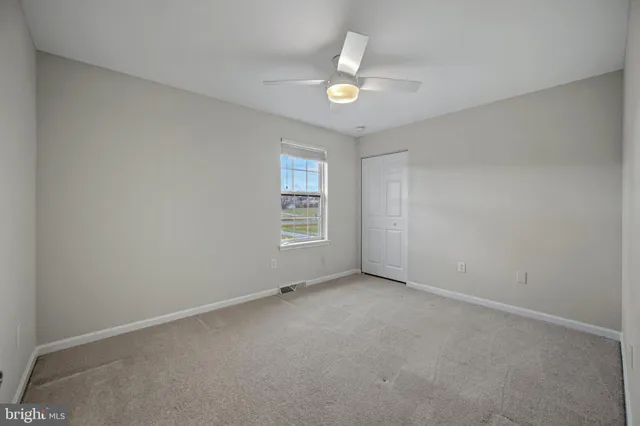 a bedroom with a large bed and paintings on the wall