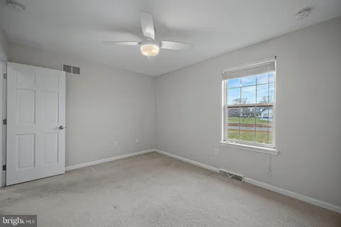a spacious bedroom with a bed and a cabinets