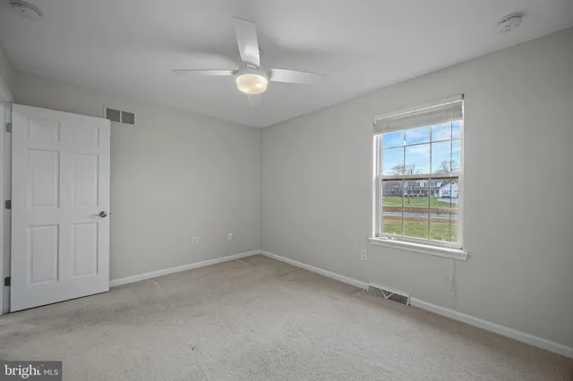 a spacious bedroom with a bed and a cabinets