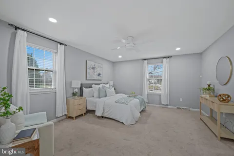a bathroom with a double vanity sink a mirror and a shower