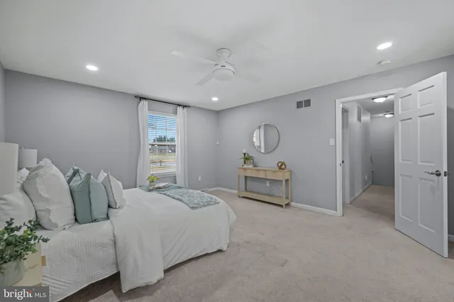 a view of an empty room with a staircase