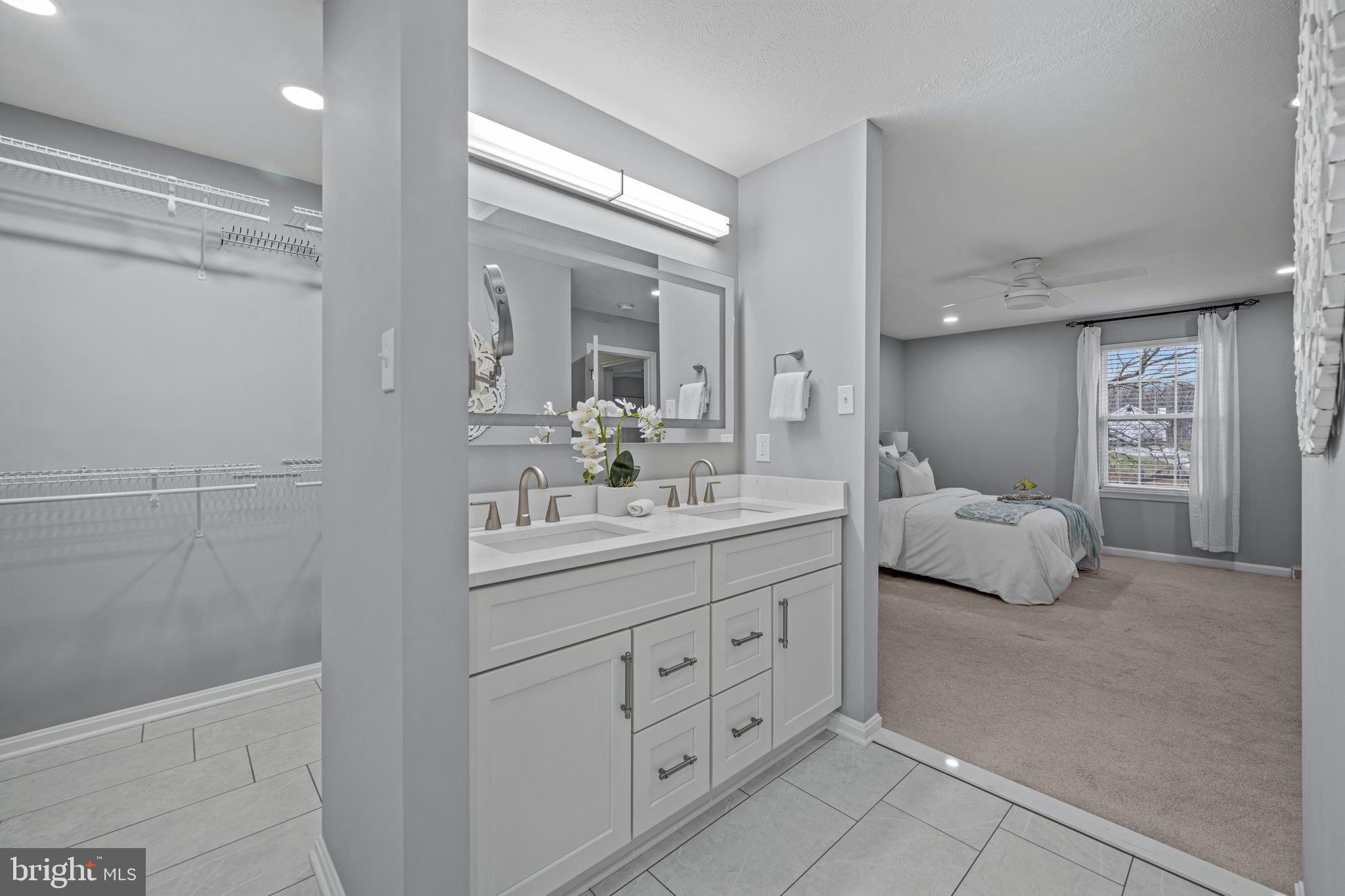 3211 Hayloft Court Woodbine, MD 21797 - Photo 31 of 69 a bathroom with a double vanity sink a mirror and a shower