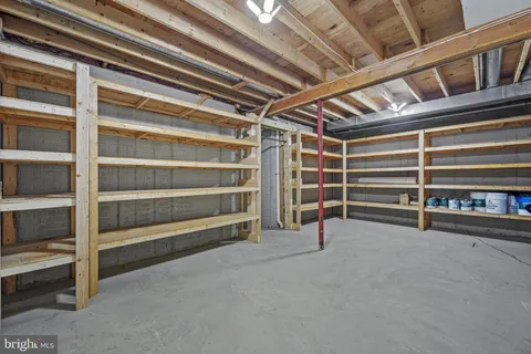 a living room with furniture a flat screen tv and a chandelier