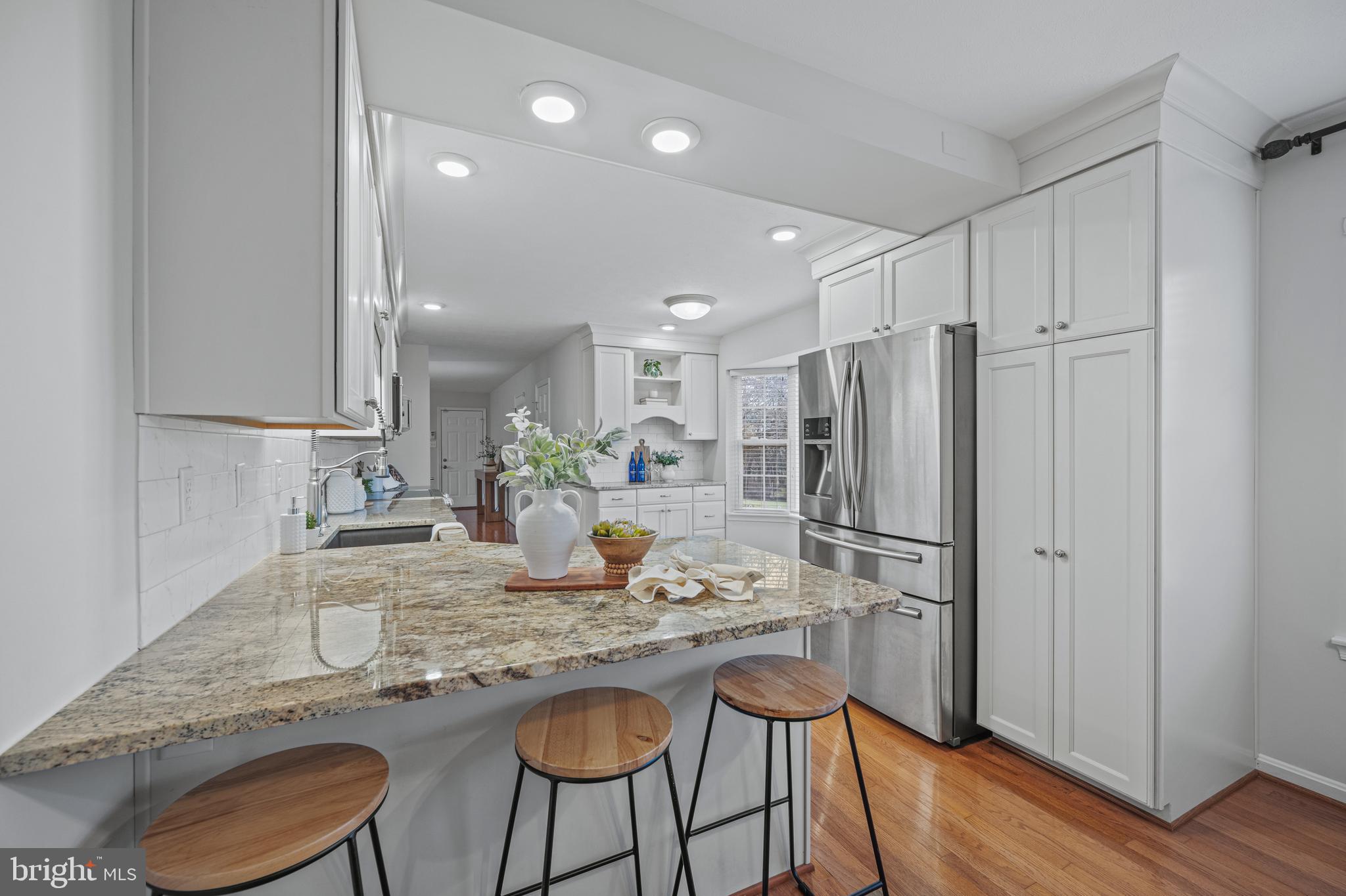 3211 Hayloft Court Woodbine, MD 21797 - Photo 7 of 69 a kitchen with refrigerator a sink and chairs