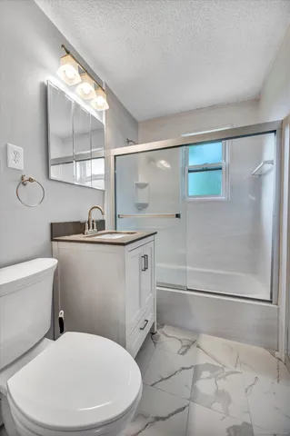 a white toilet sitting next to a bathroom sink