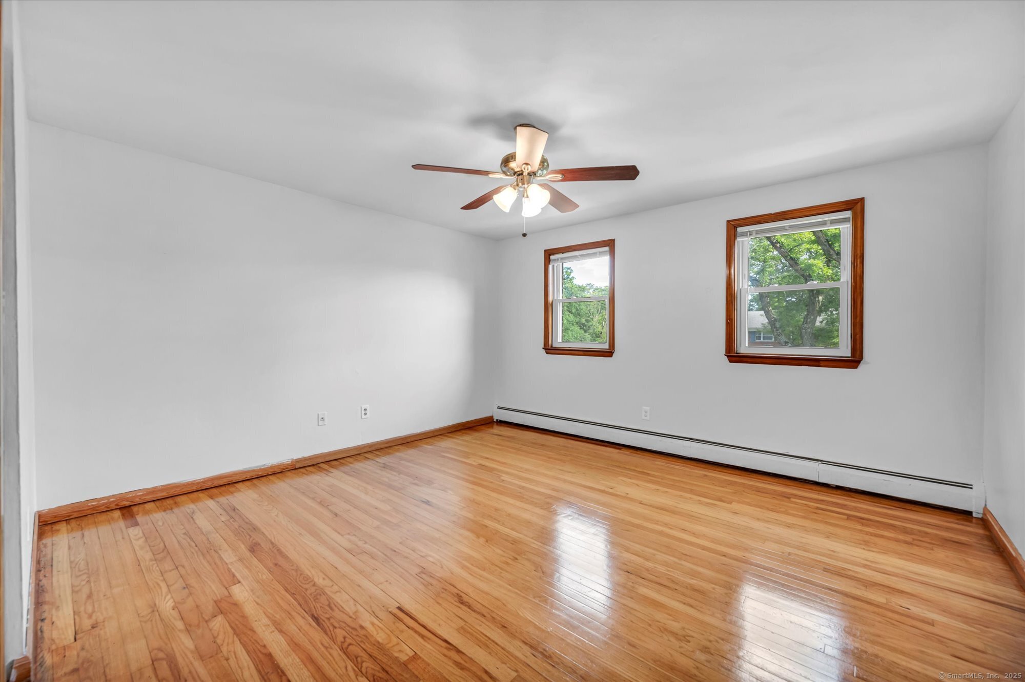 26 Colonial Drive, Unit C Rocky Hill, CT 06067 - Photo 14 of 14 a view of empty room with wooden floor and fan