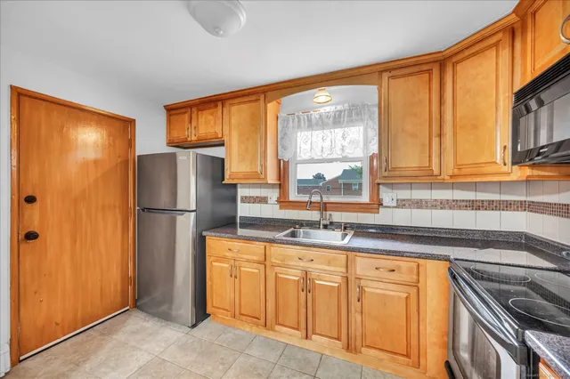 a kitchen with appliances cabinets and a sink