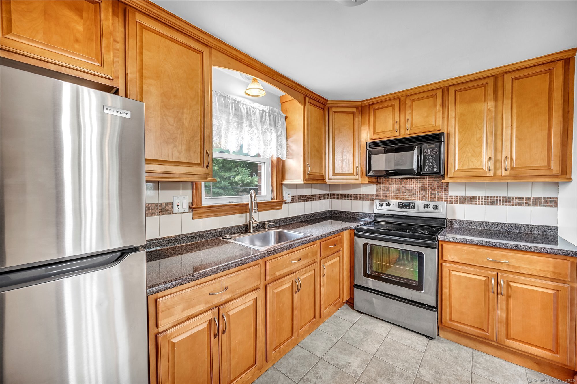 26 Colonial Drive, Unit C Rocky Hill, CT 06067 - Photo 4 of 14 a kitchen with granite countertop a sink cabinets stainless steel appliances and a window