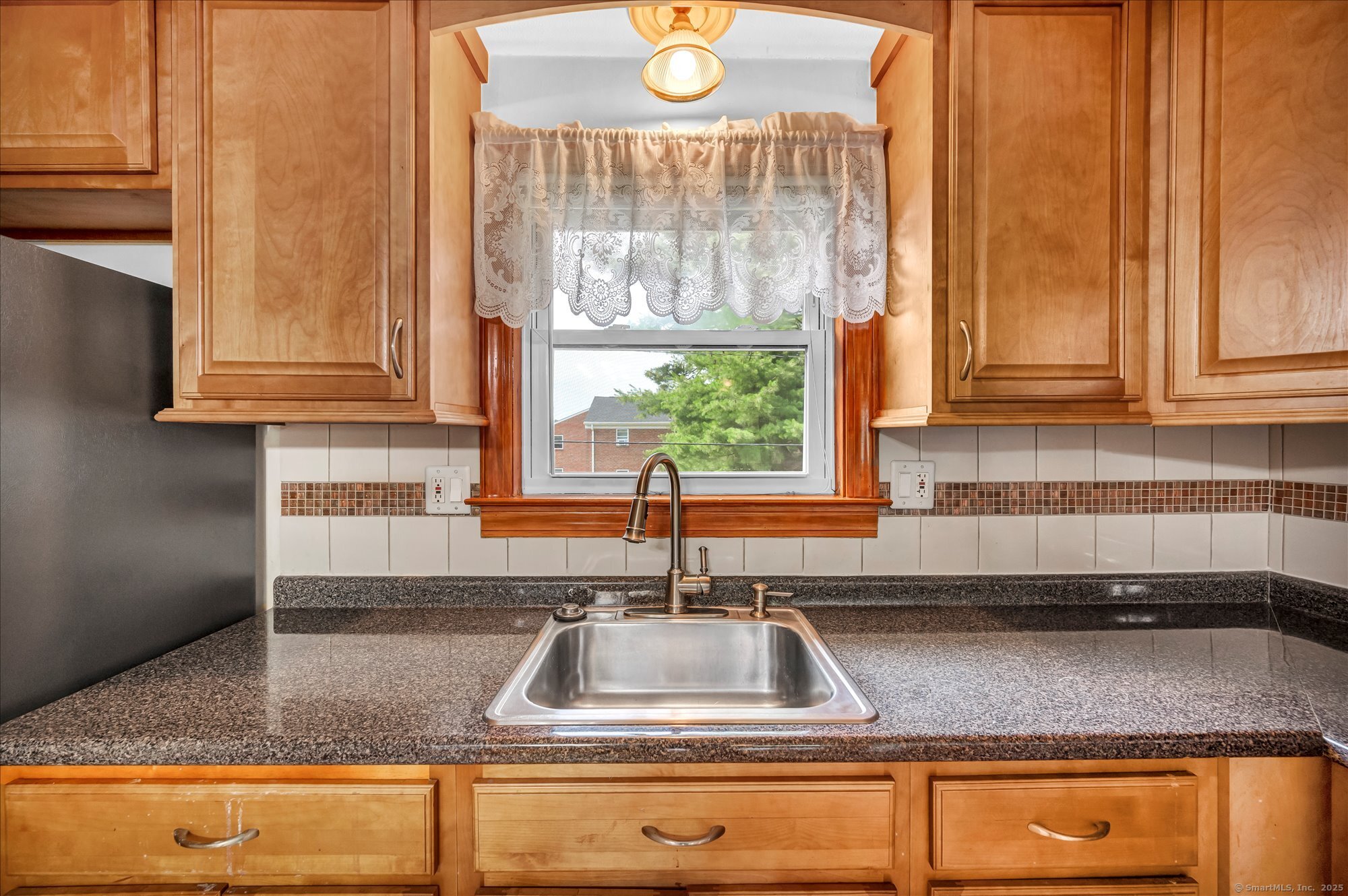 26 Colonial Drive, Unit C Rocky Hill, CT 06067 - Photo 5 of 14 a kitchen with granite countertop a sink a window and cabinets