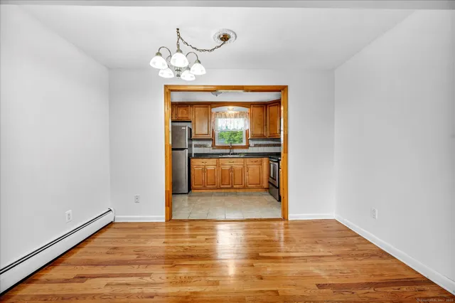 a view of a room with wooden floor and window