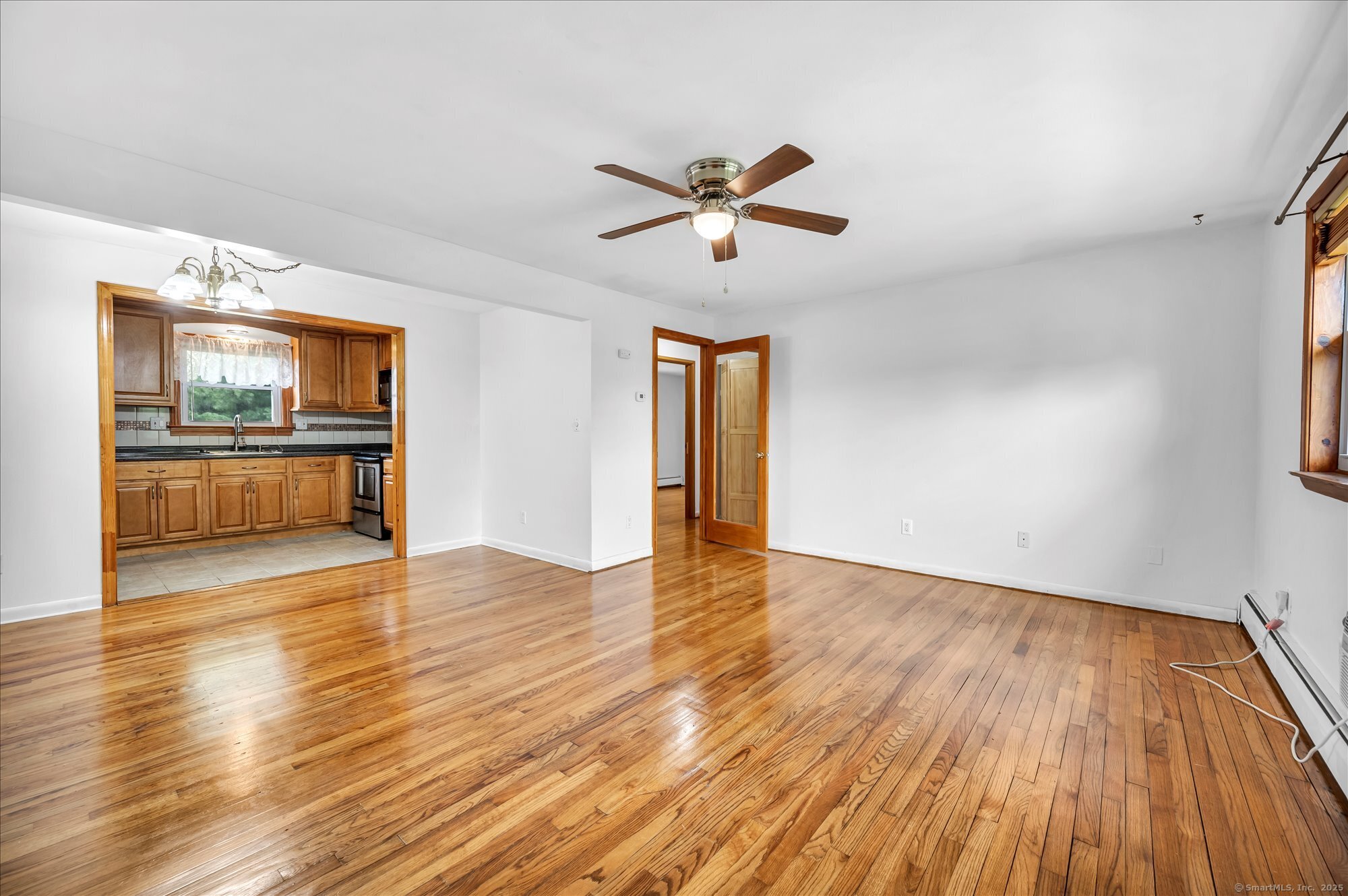 26 Colonial Drive, Unit C Rocky Hill, CT 06067 - Photo 7 of 14 a view of empty room with wooden floor and fan