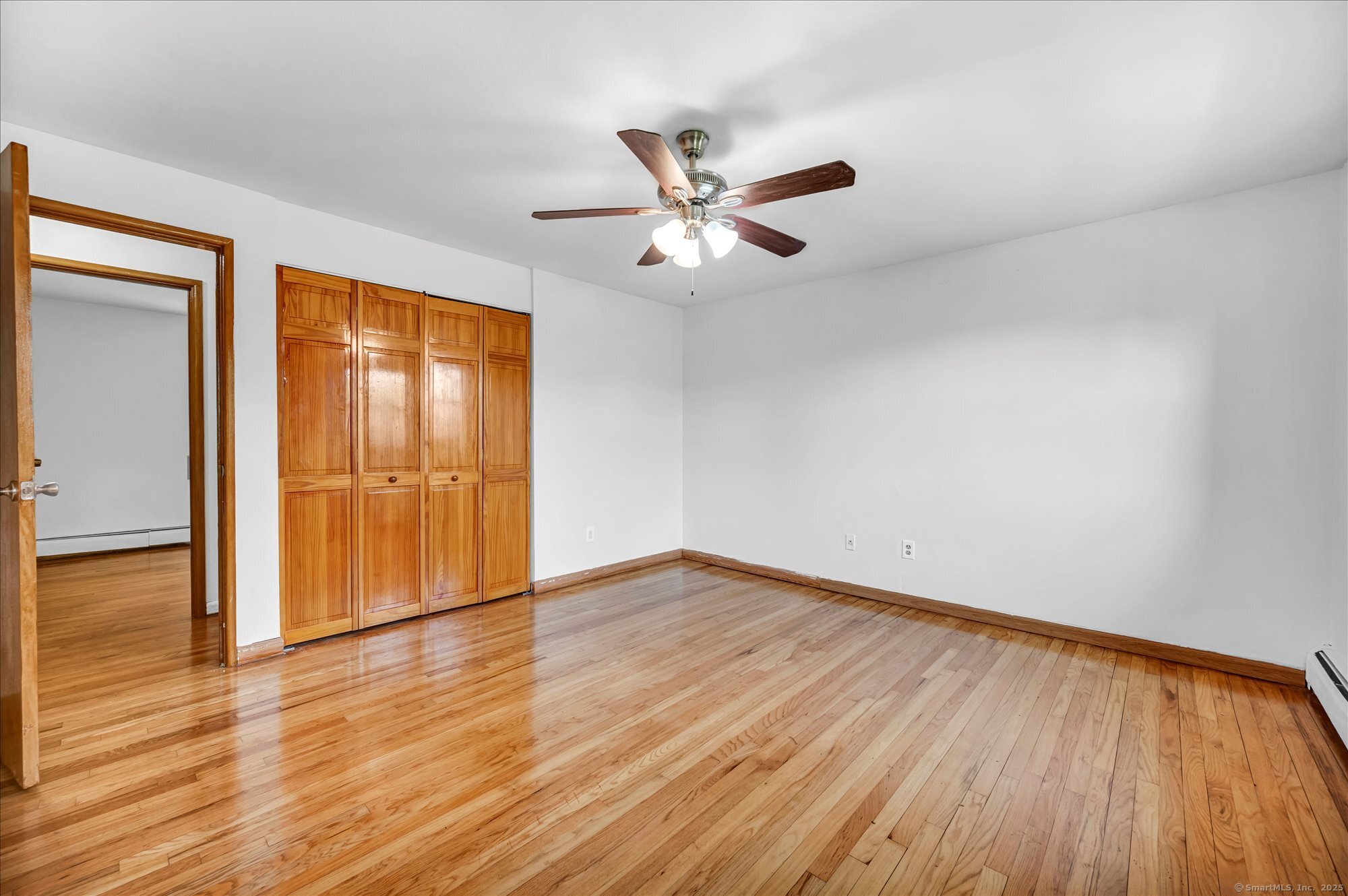 26 Colonial Drive, Unit C Rocky Hill, CT 06067 - Photo 8 of 14 an empty room with wooden floor and windows